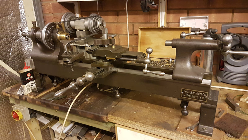 Lorch Toolmakers lathe from circa. 1905.  Very old but very useful.  I have many chucks for this and many collets. It's great for polishing larger parts.